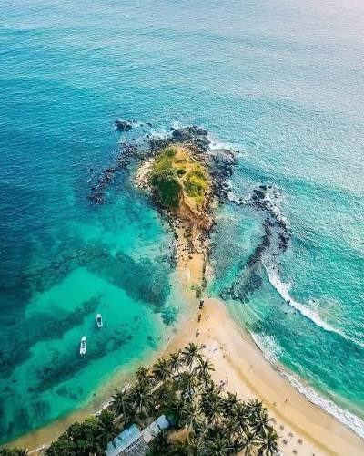 Parrot Rock rising from the sea off Mirissa beach